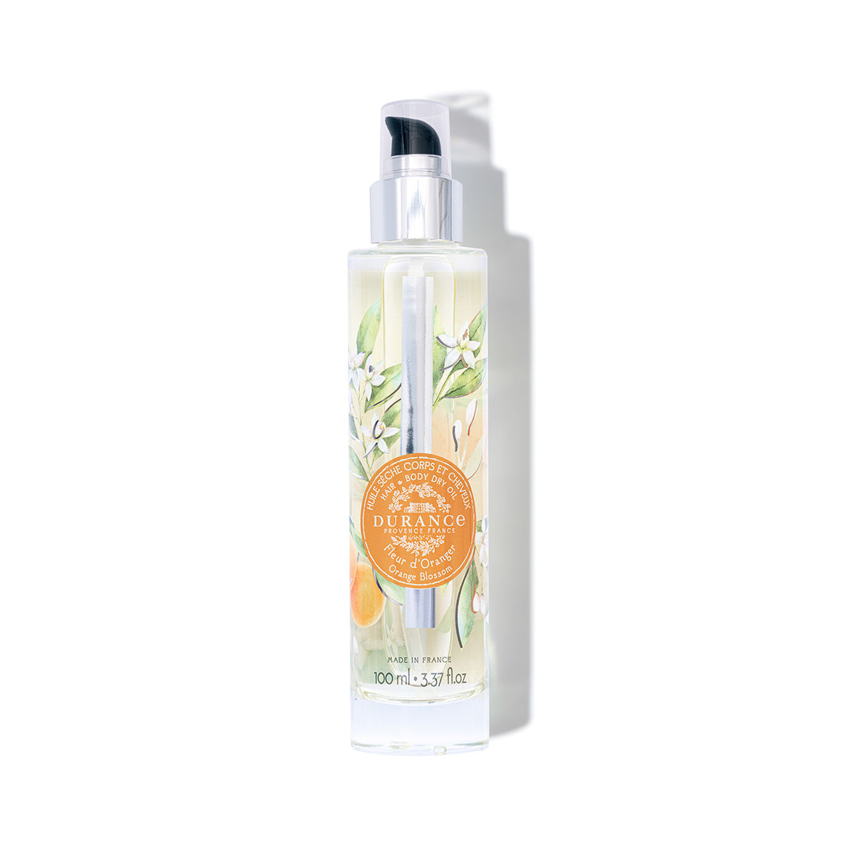 grosse runde pumpflasche durchsichtig mit blumen verziert duft orangenbluete trockenoel