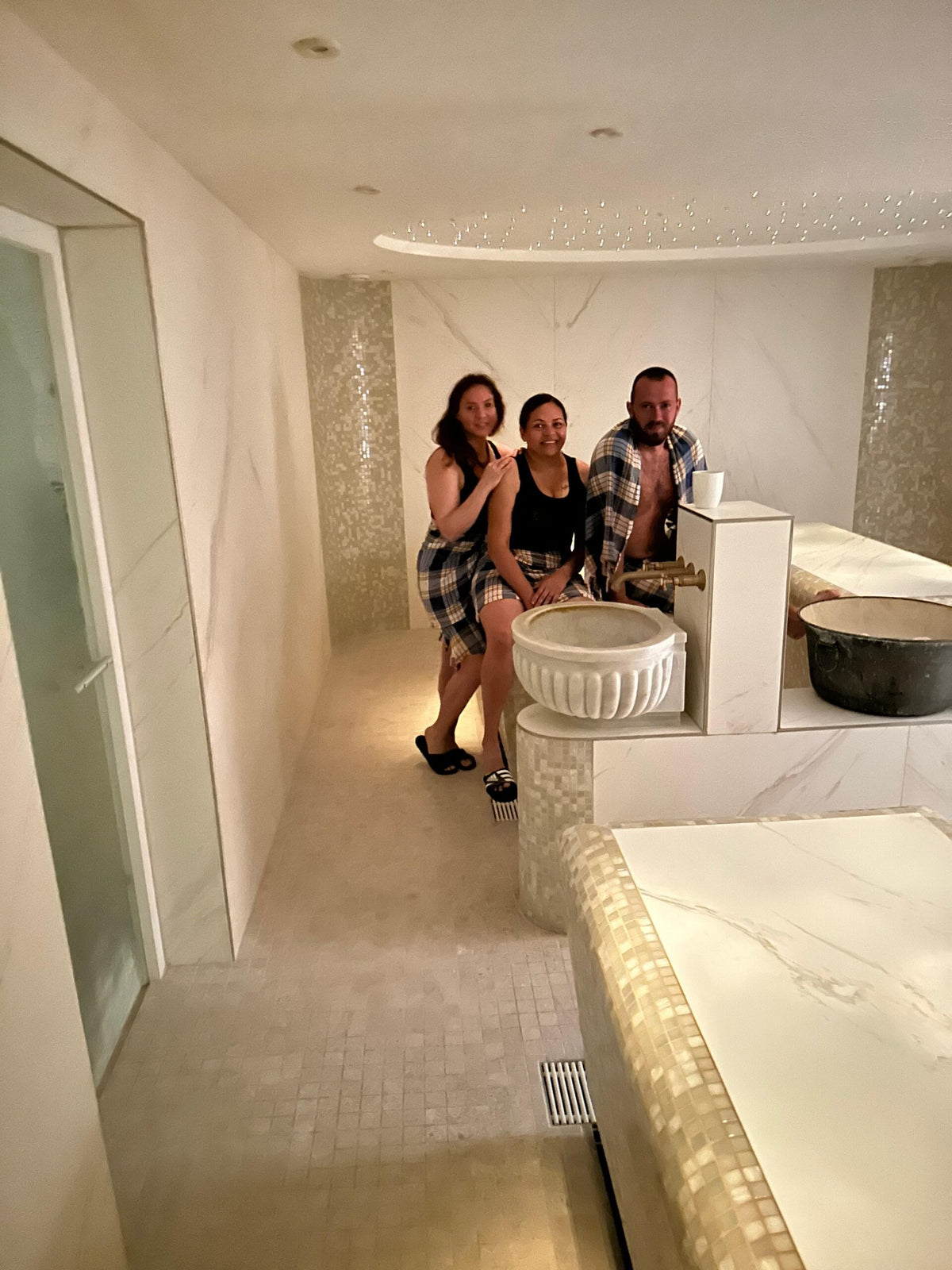 Heller Hamam-Bereich mit Marmorstein, Wasserbecken und Team im Mathilden Hamam München